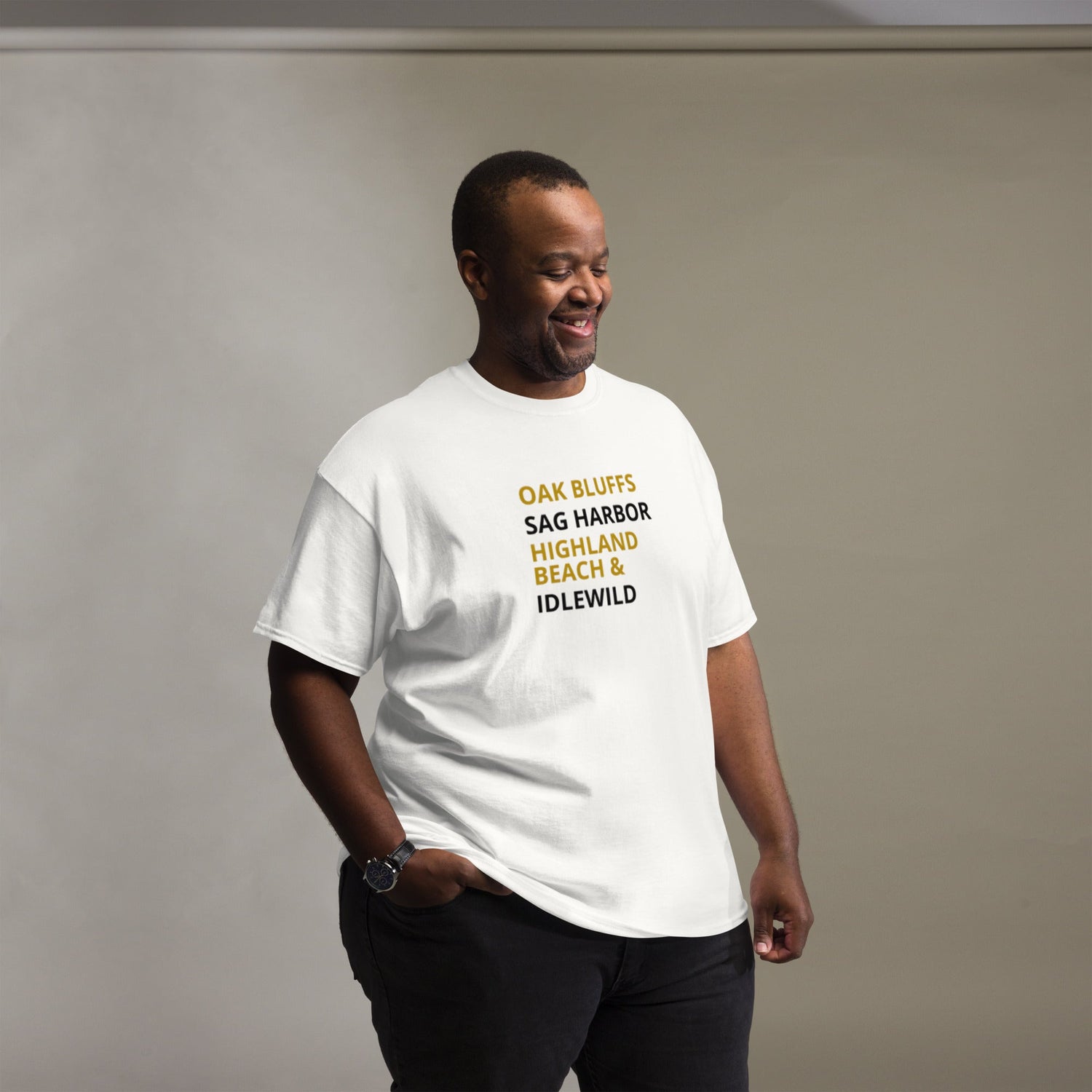 man wearing a white t-shirt with black and old gold colors