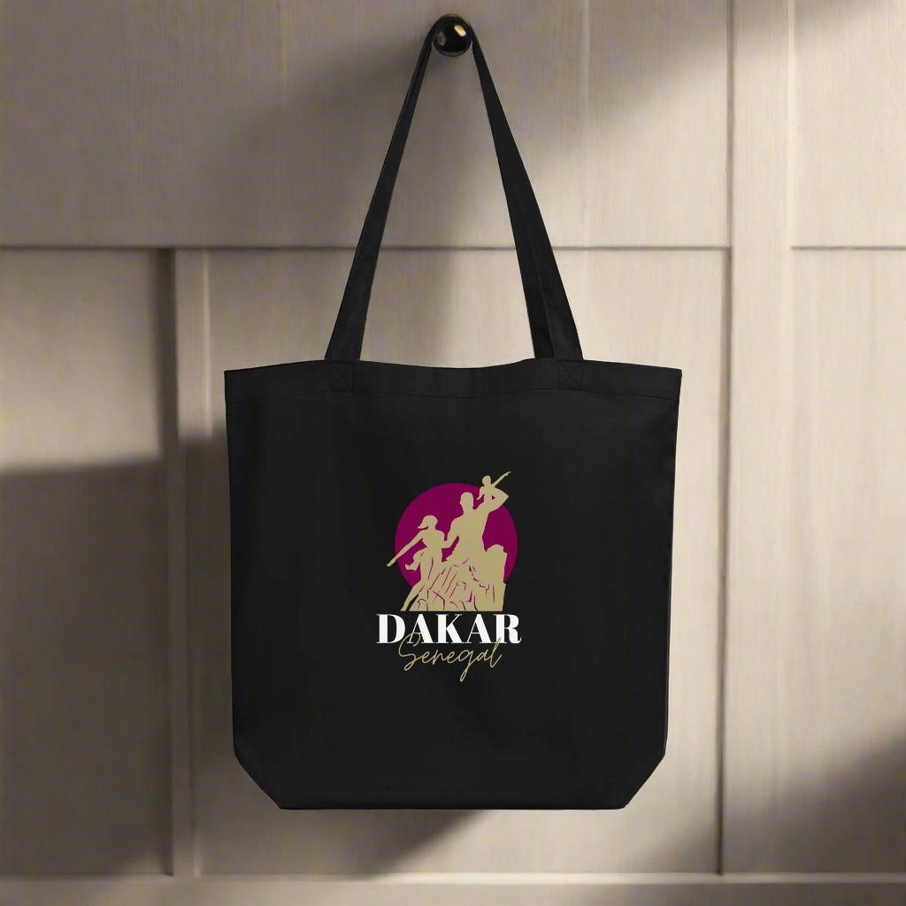 Black tote bag with 'Dakar Senegal' logo on a light wooden background
