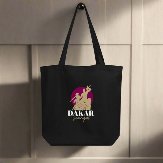 Black tote bag with 'Dakar Senegal' logo on a light wooden background