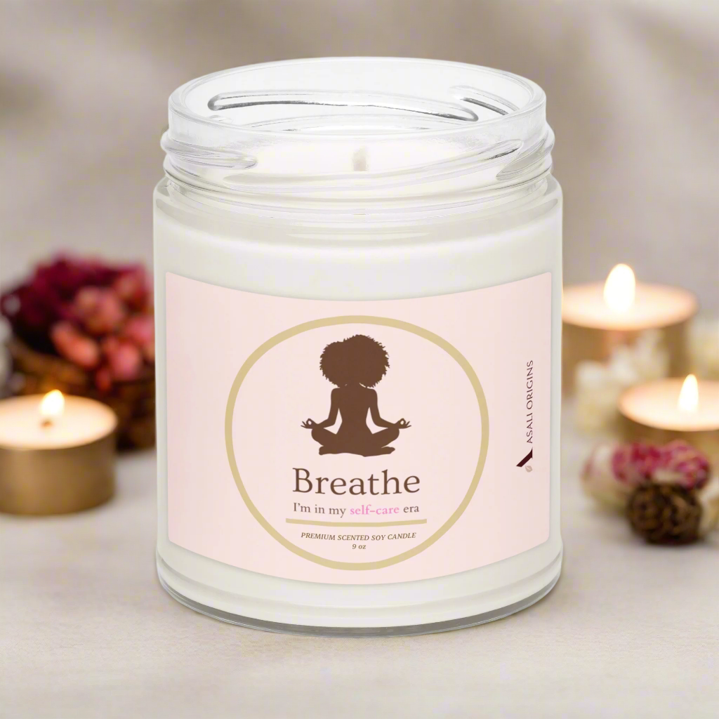 Candle in a jar with a 'Breathe' label surrounded by gold candles