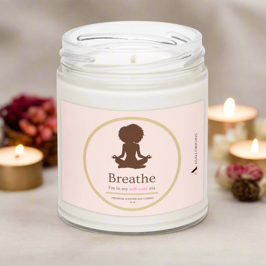 Candle in a jar with a 'Breathe' label surrounded by gold candles