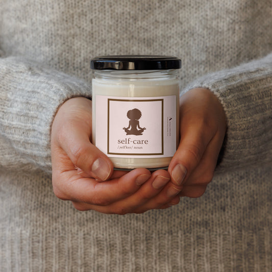 hands holding self-care label candle glass jar with lid