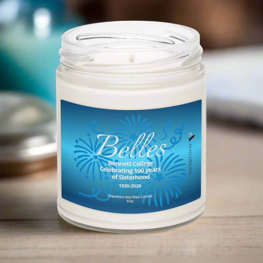 Candle jar with a blue label featuring 'Belles' and 'Bennett College' on a wooden surface.