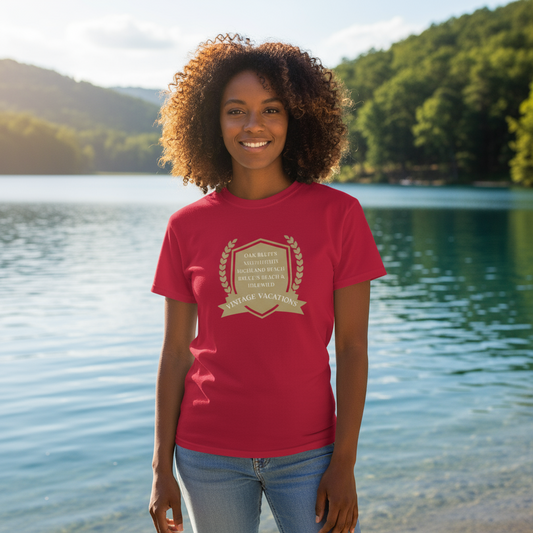 Woman wearing a red t-shirt with a logo standing by a lake