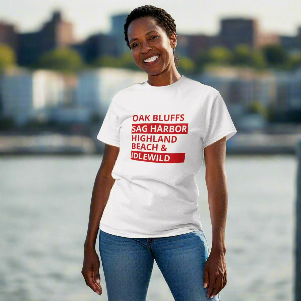 Woman wearing a white t-shirt with red text by a waterfront