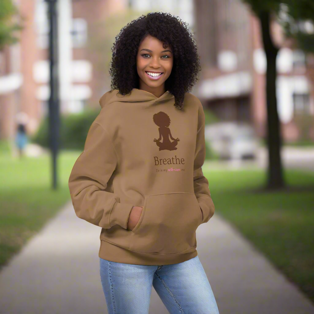 Woman wearing a brown hoodie with 'Breathe' text outdoors