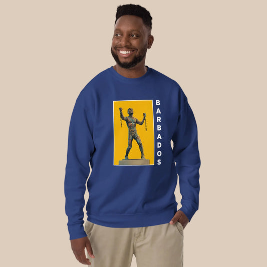 Model wearing a black Bussa Statue sweatshirt with the monument illustrated against a gold rectangle and white BARBADOS lettering down the side.