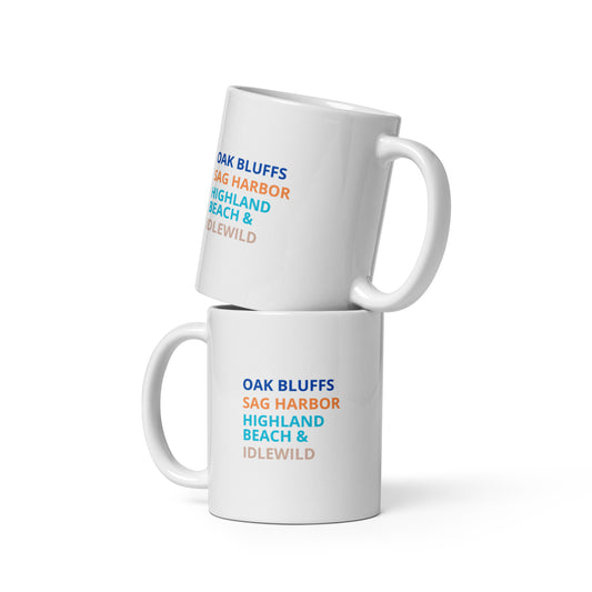 white mug with text listing locations on a white background. 