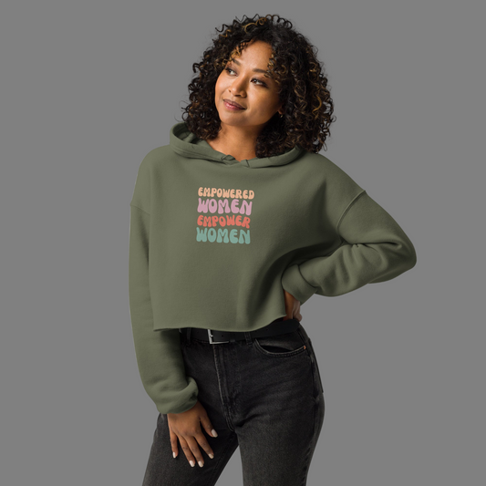 Woman wearing a green hoodie with 'Empowered Women Empower Women' text on a gray background